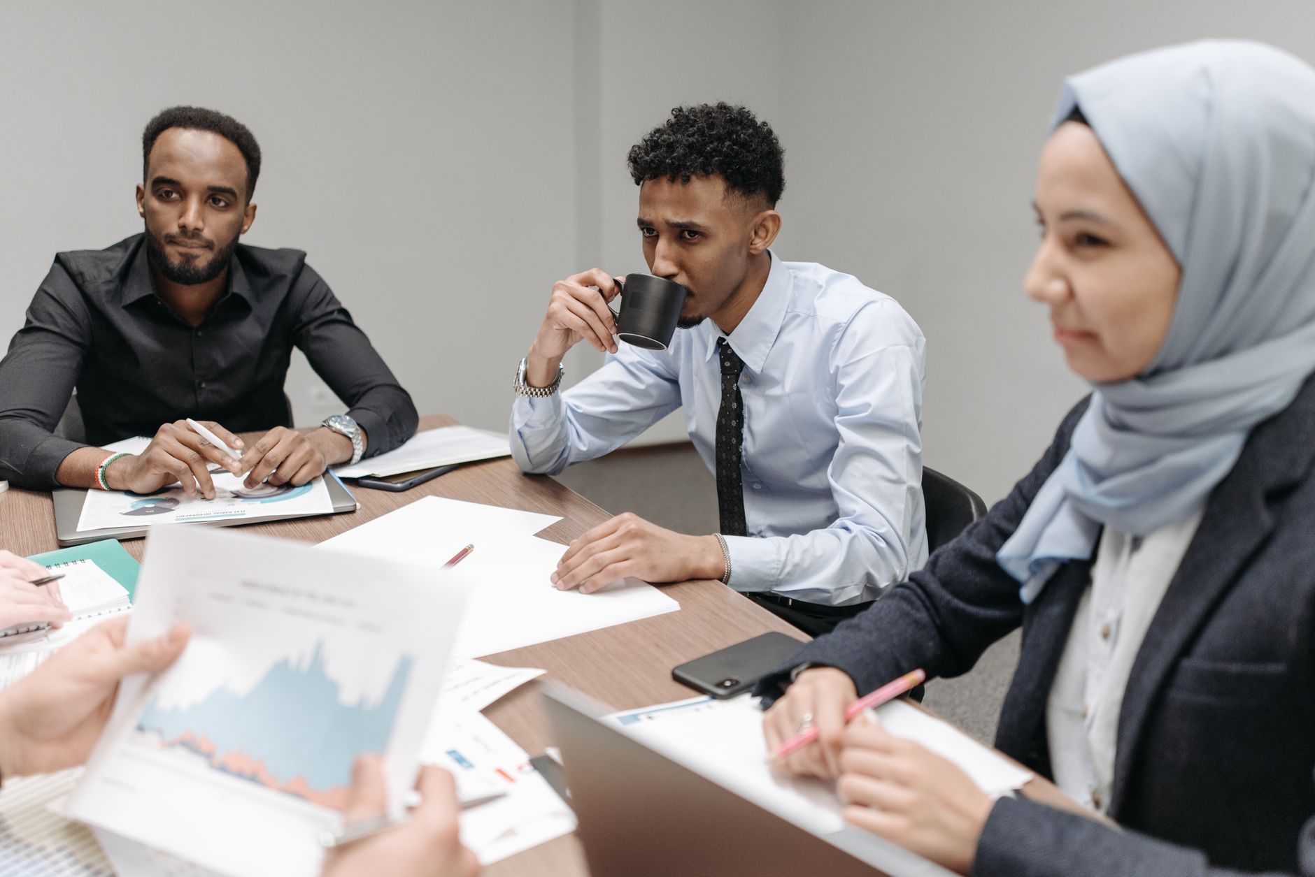 A multicultural team engaged in discussion during an office meeting, highlighting diversity and teamwork. — Experience a Stre