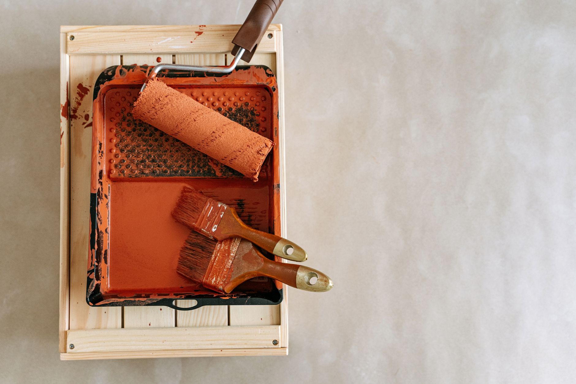 An overhead shot of paintbrushes and a roller in a tray, perfect for home renovation projects. — Why would I need a sump pump